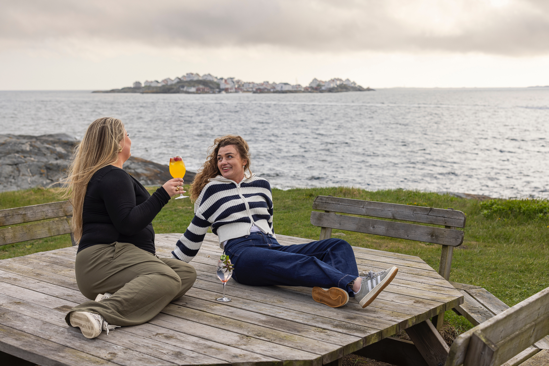 Vänner med drinkar vid havet på Dyrön